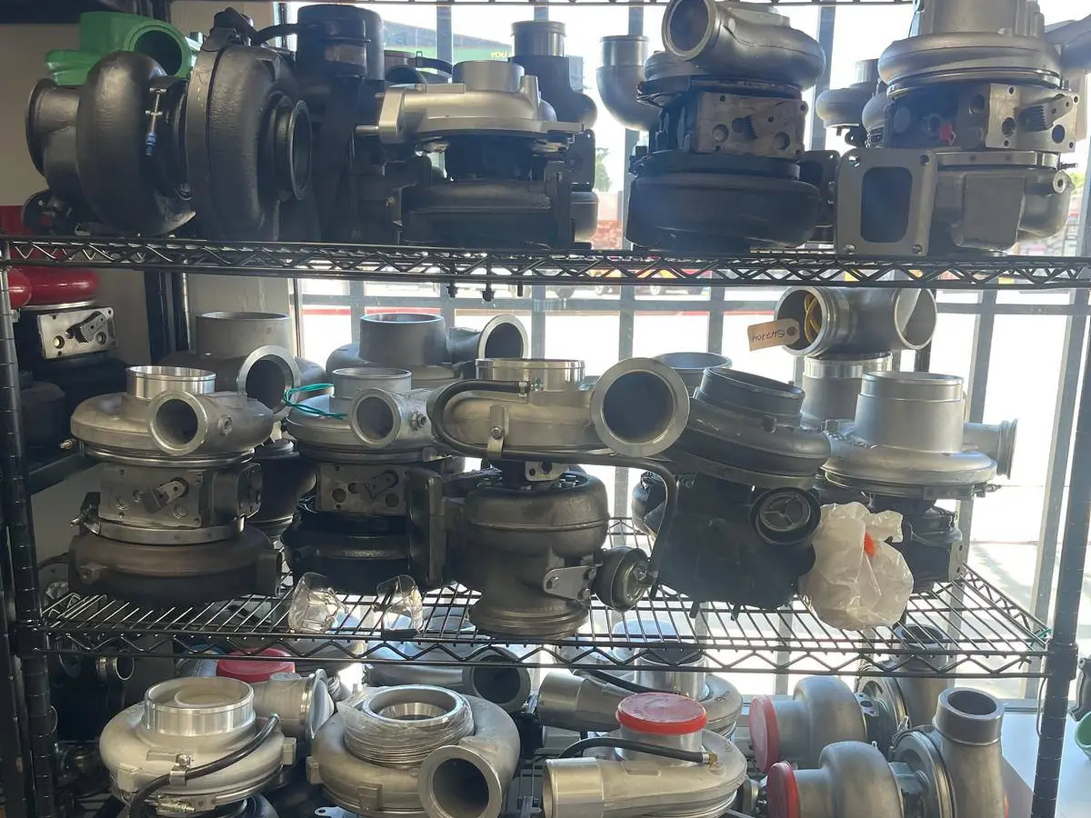 Racks of turbochargers in the shop — diesel and gas units, cores and rebuilds